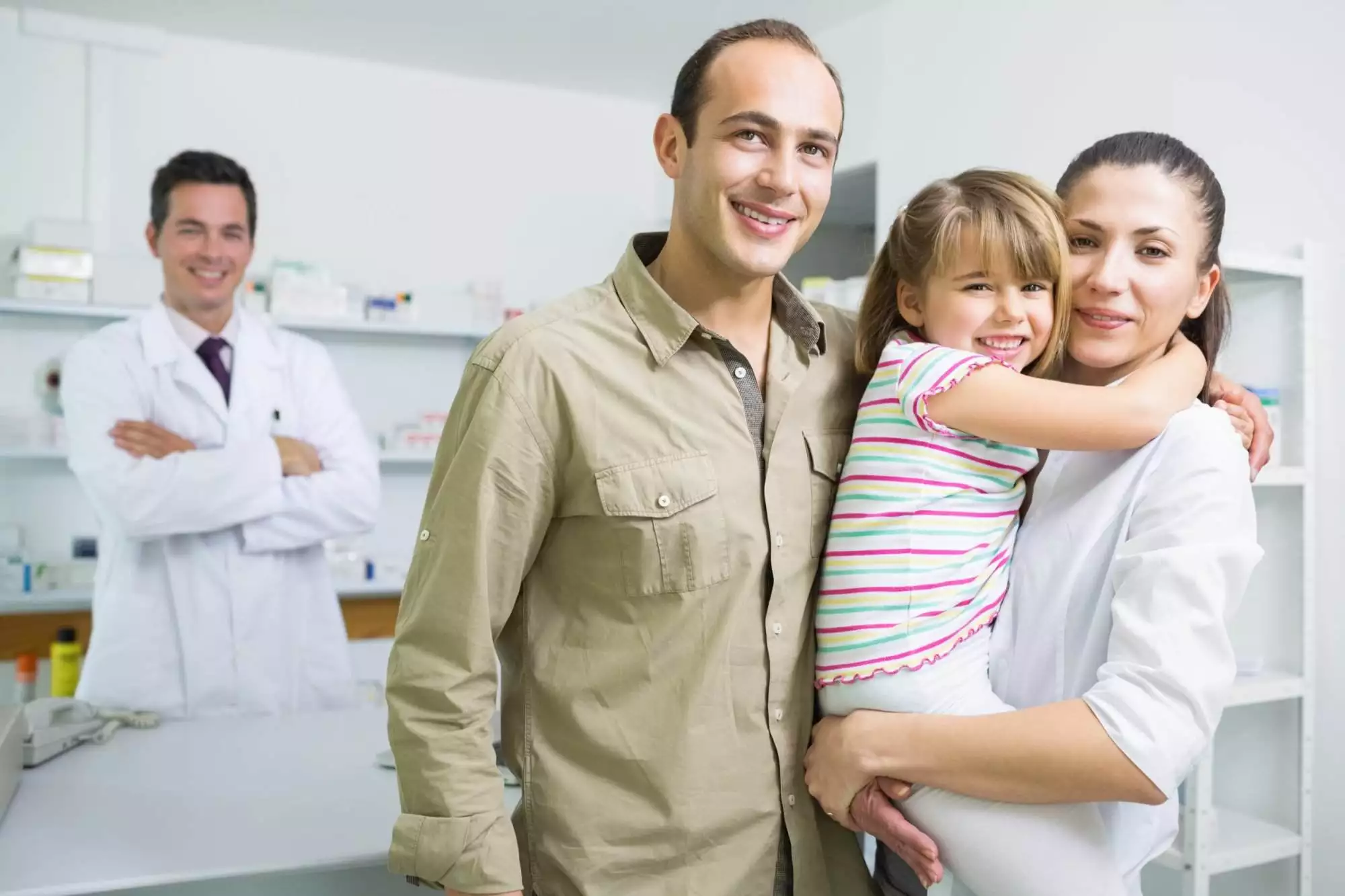 Smiling family and a pharmacist in the pharmacy of a hospital